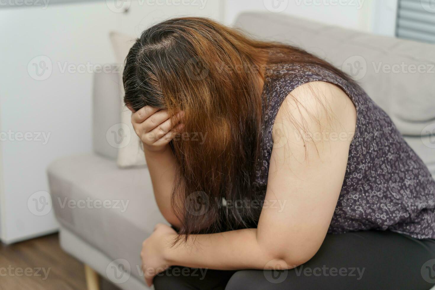 Sad Overweight plus size woman thinking about problems on sofa upset girl feeling lonely and sad from bad relationship or Depressed woman disorder mental health photo