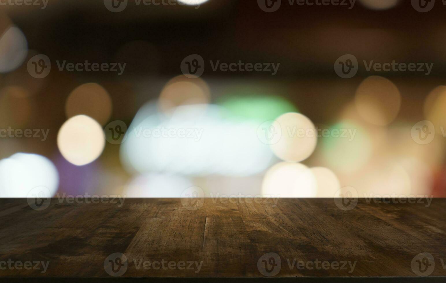 Mock up for space. Empty dark wooden table in front of abstract blurred bokeh background of restaurant . can be used for display or montage your product photo