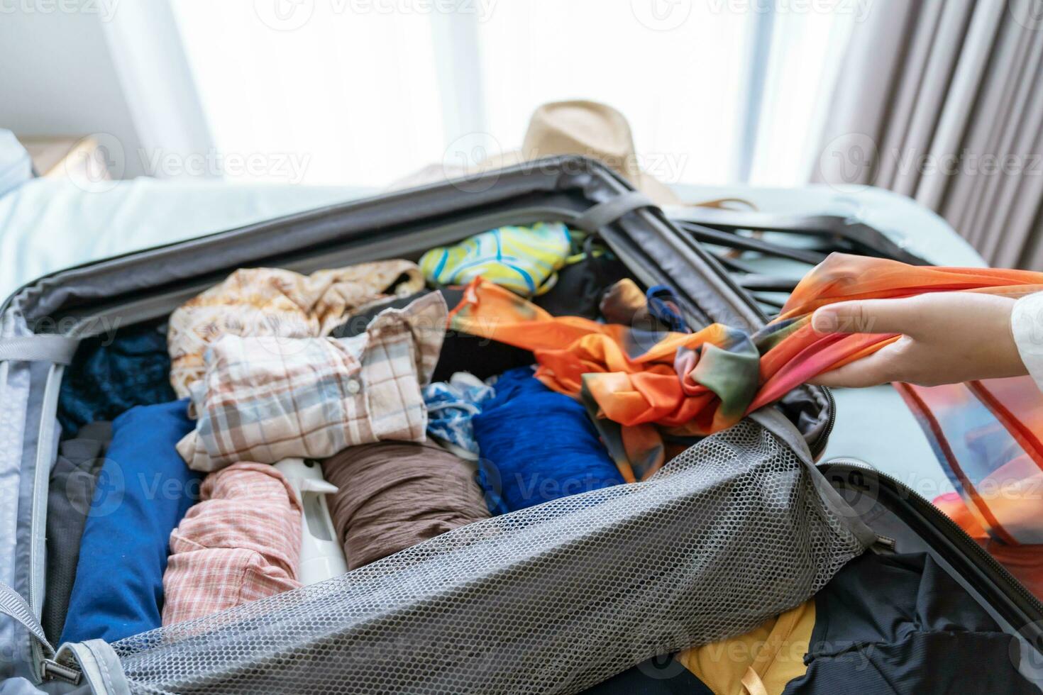 Woman packing suitcase on bed for a new journey packing list for travel planning preparing vacation Book Now Traveling Transportation photo