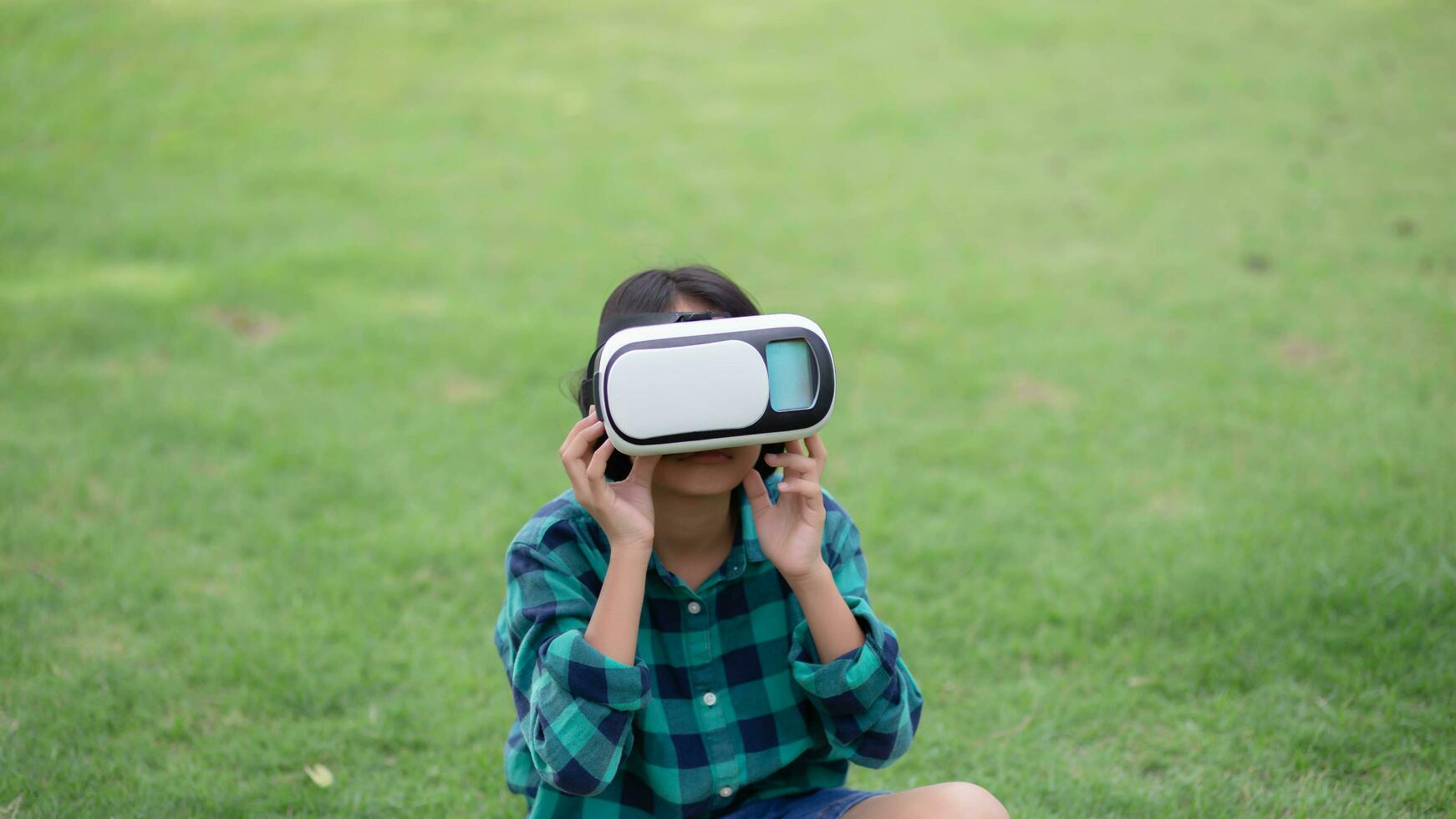 Young girl kid child play virtual reality game hold vr glasses and surprised. Cyber space and virtual gaming .SSTKHome photo