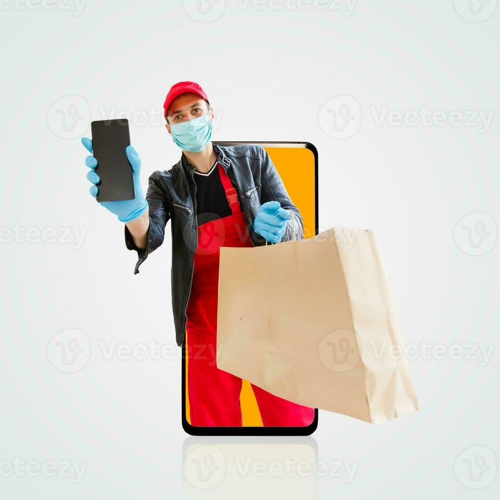 Delivery man in cap k t-shirt uniform face mask gloves hold cardboard box isolated on color background. Service quarantine pandemic coronavirus virus 2019-ncov concept photo