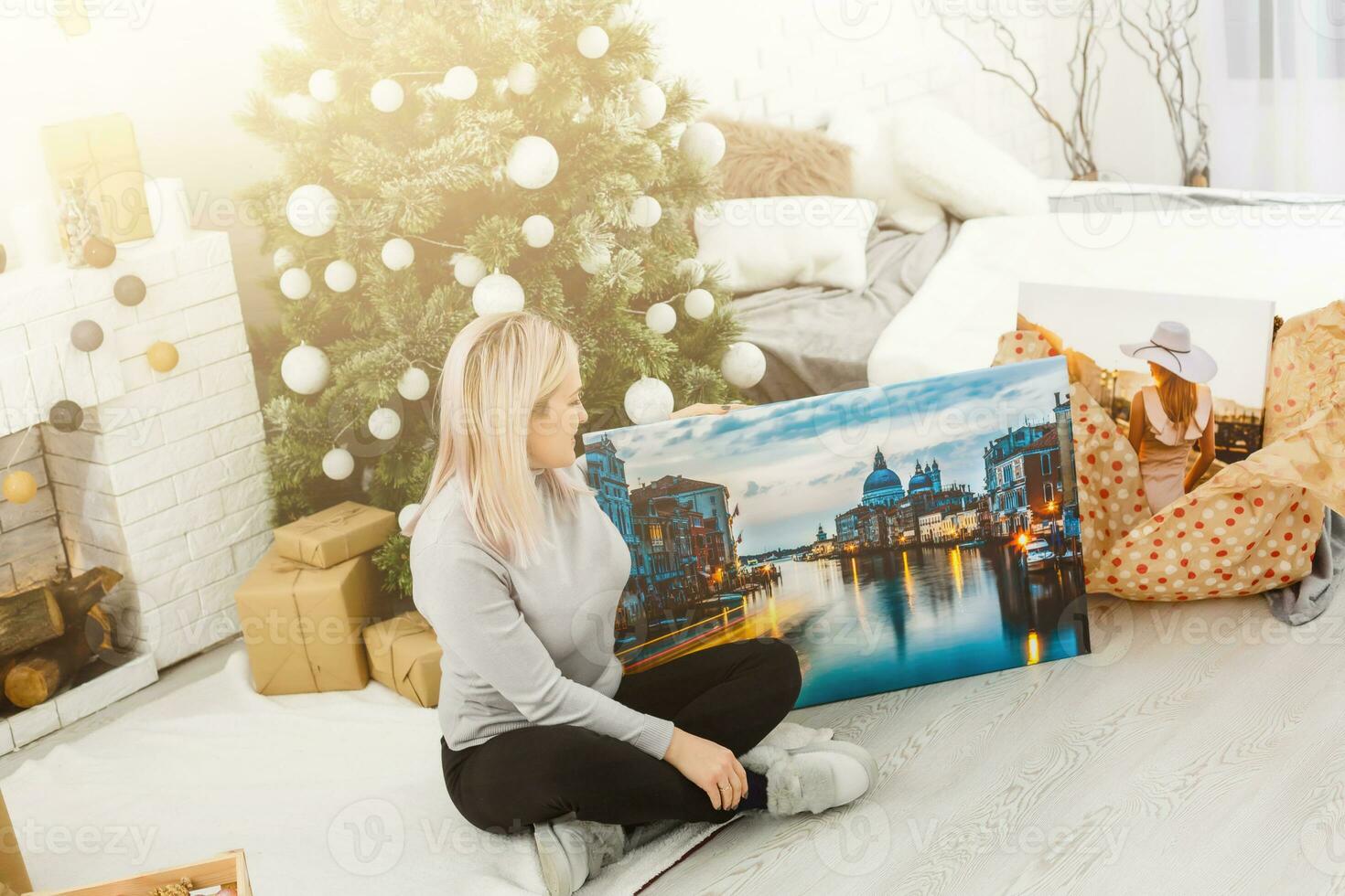 girl holds photo canvas as a christmas present