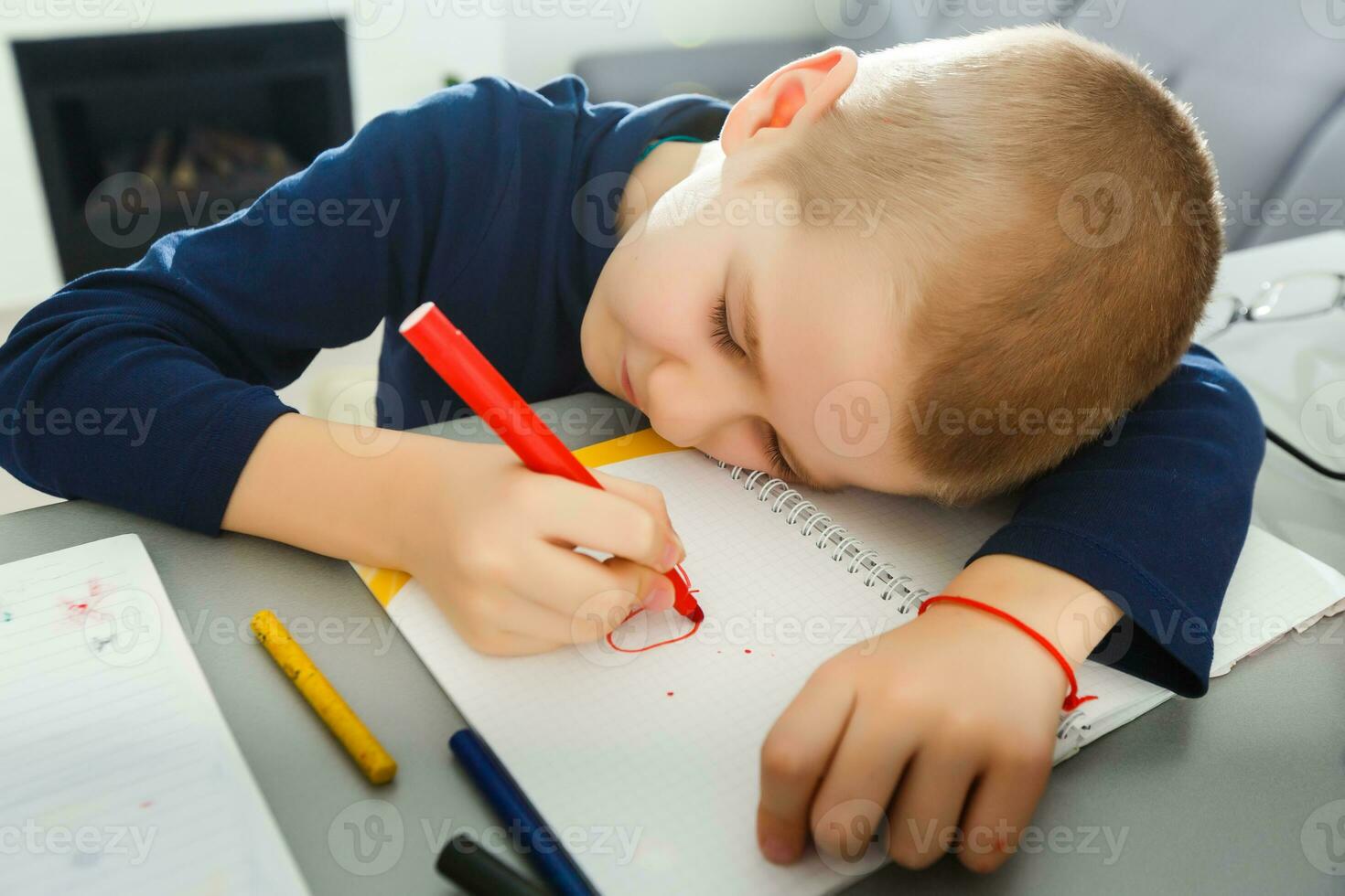 Educational theme boy teenager sleeping on his books. Isolated over white background. photo