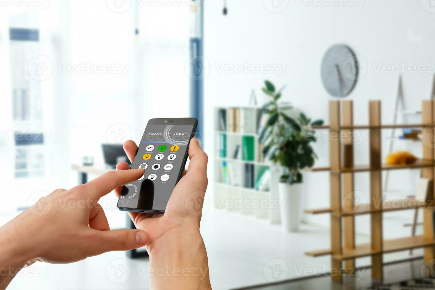 smart house, home automation, device with app icons. Man uses his smartphone with smarthome security app to unlock the door of his house. photo