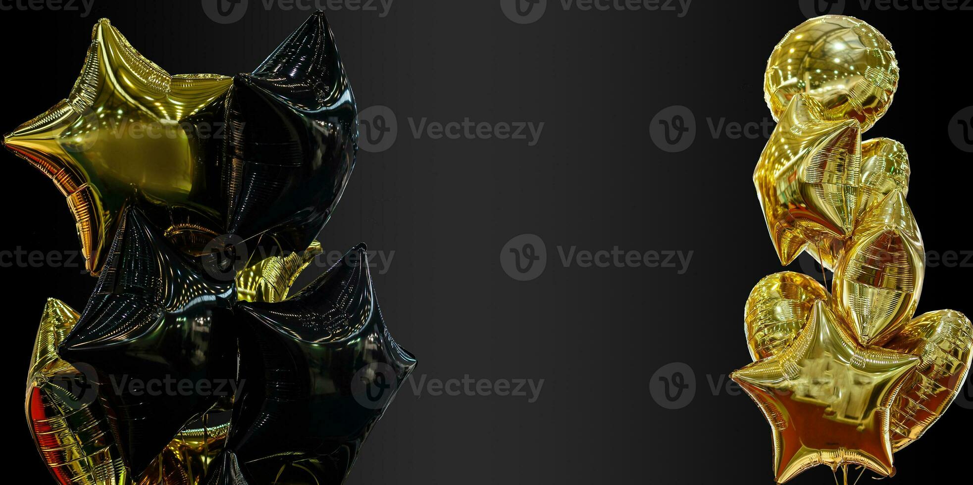 A group of black and gold balloons on a black background with copy space photo