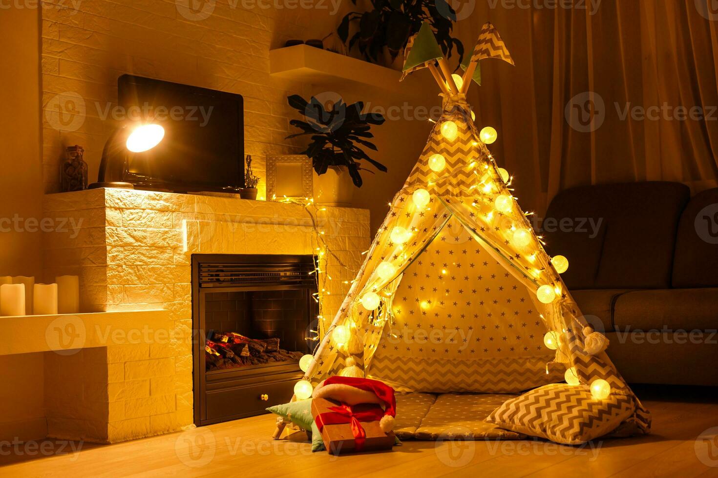 Spacious child room with window, play tent, pattern carpet, sofa, fireplace photo