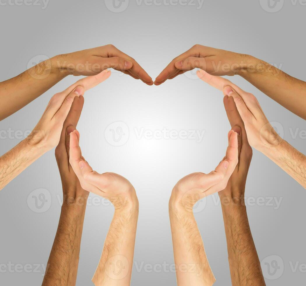 Hands make heart shape on a gray background photo