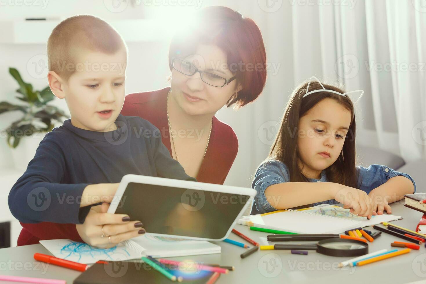 Pupils In Class Using Digital Tablet With Teacher photo