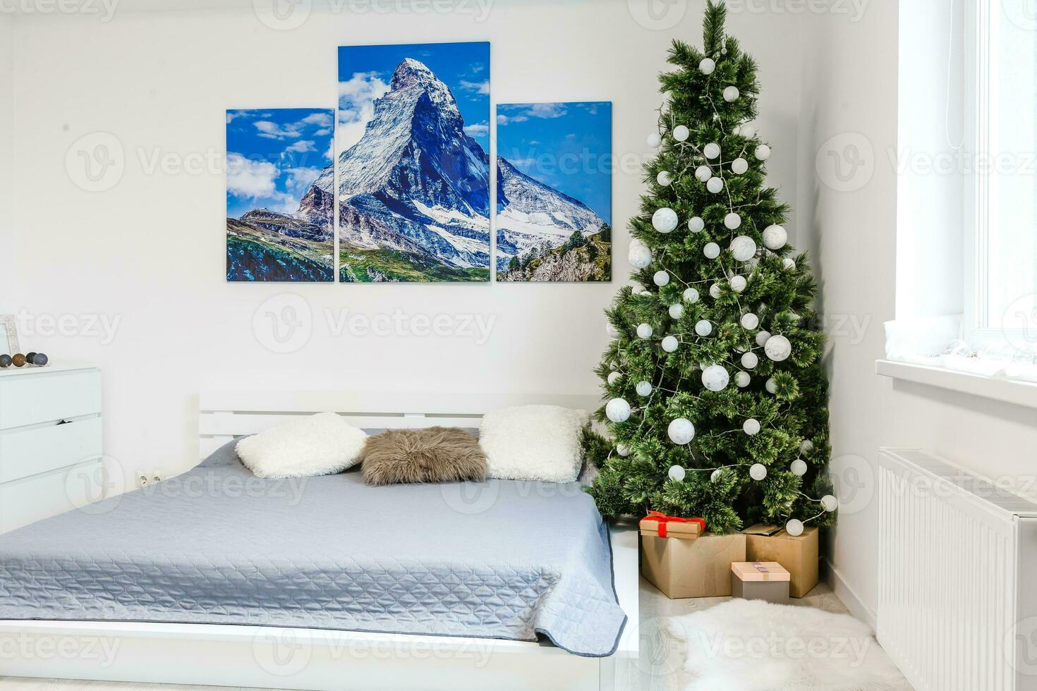 Calm image of interior Classic New Year Tree decorated in a room with bed photo