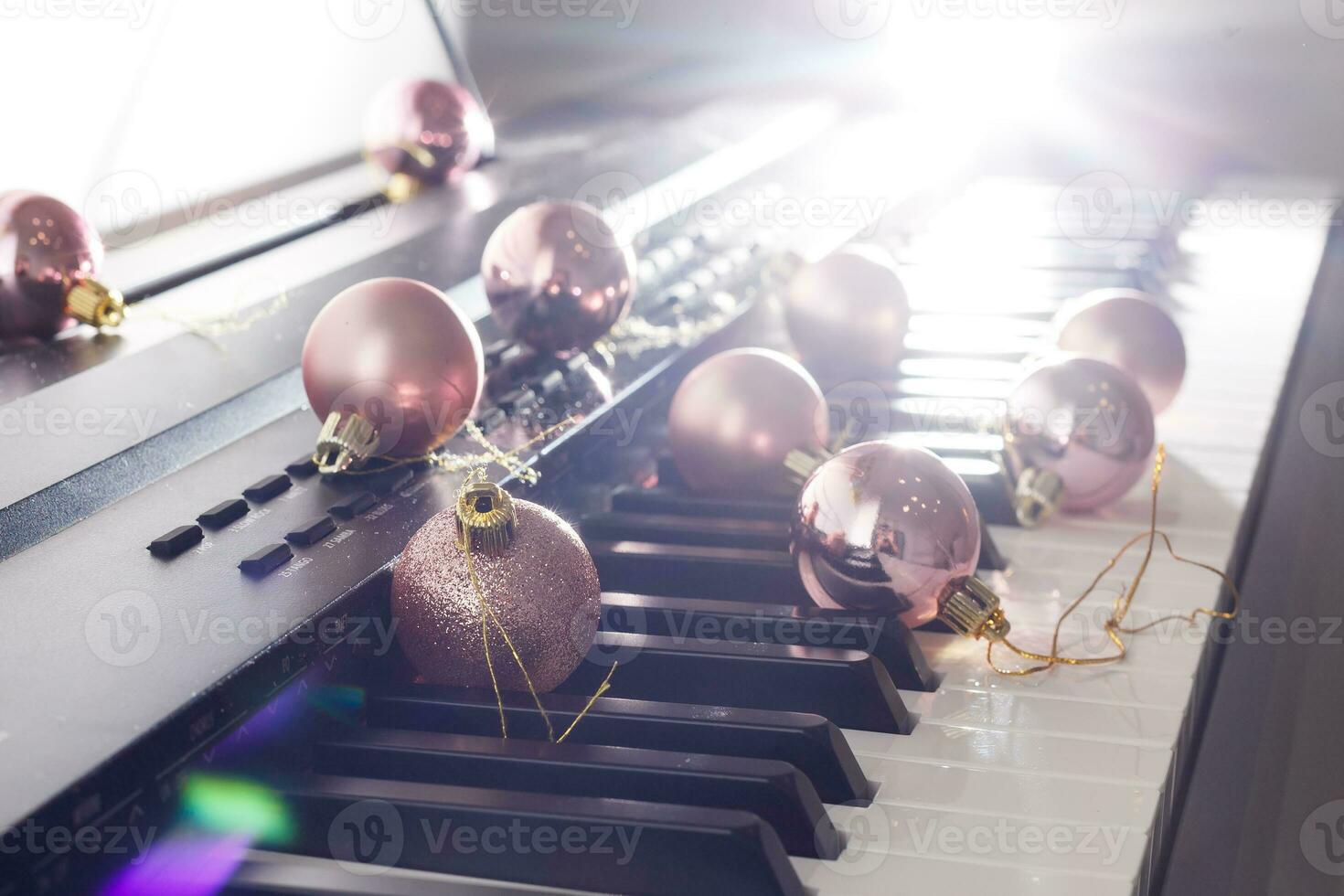 Piano keyboard with Christmas decoration, closeup photo