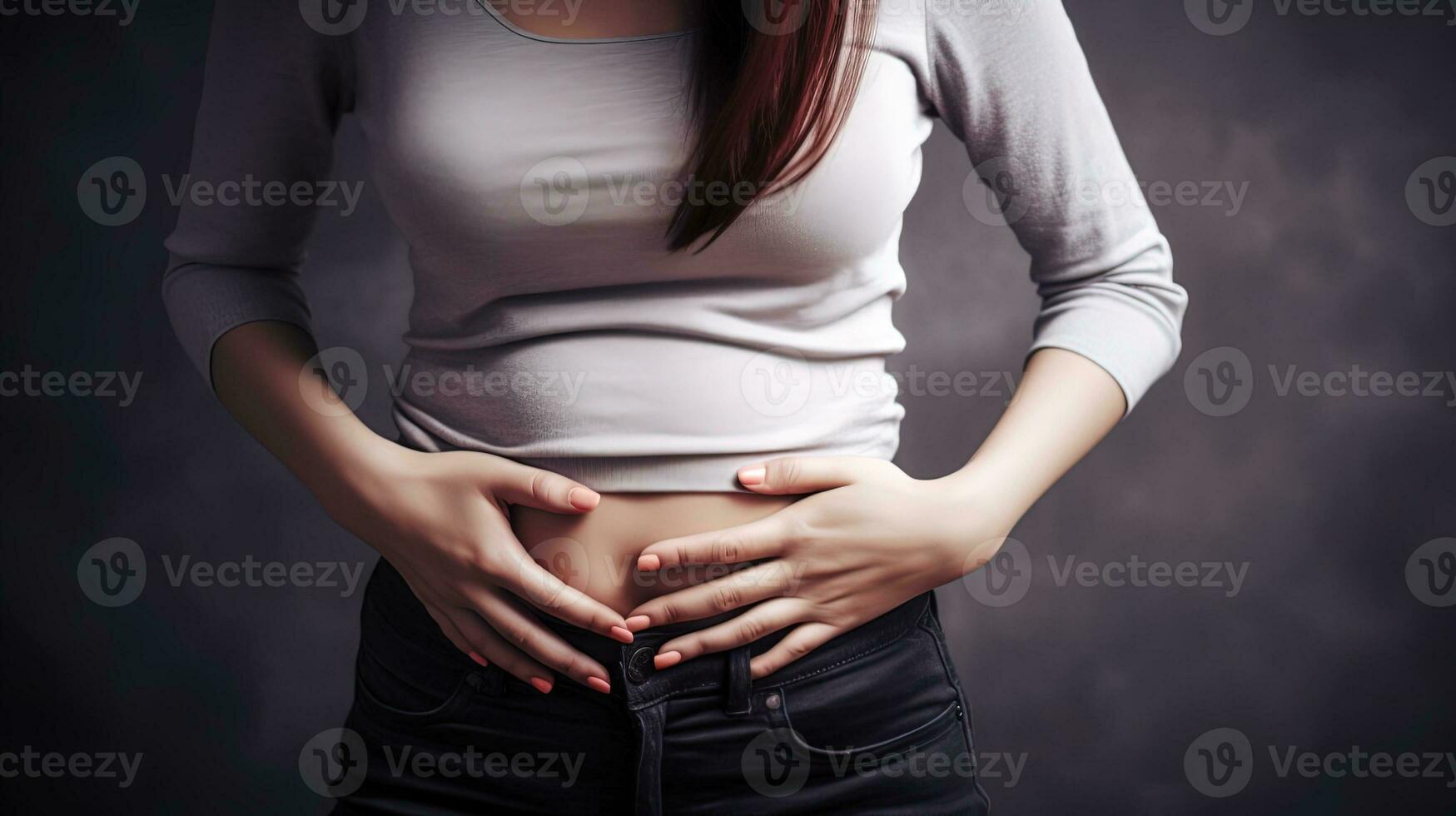 woman holding her hands in the lower abdomen, acute pain, no face photo