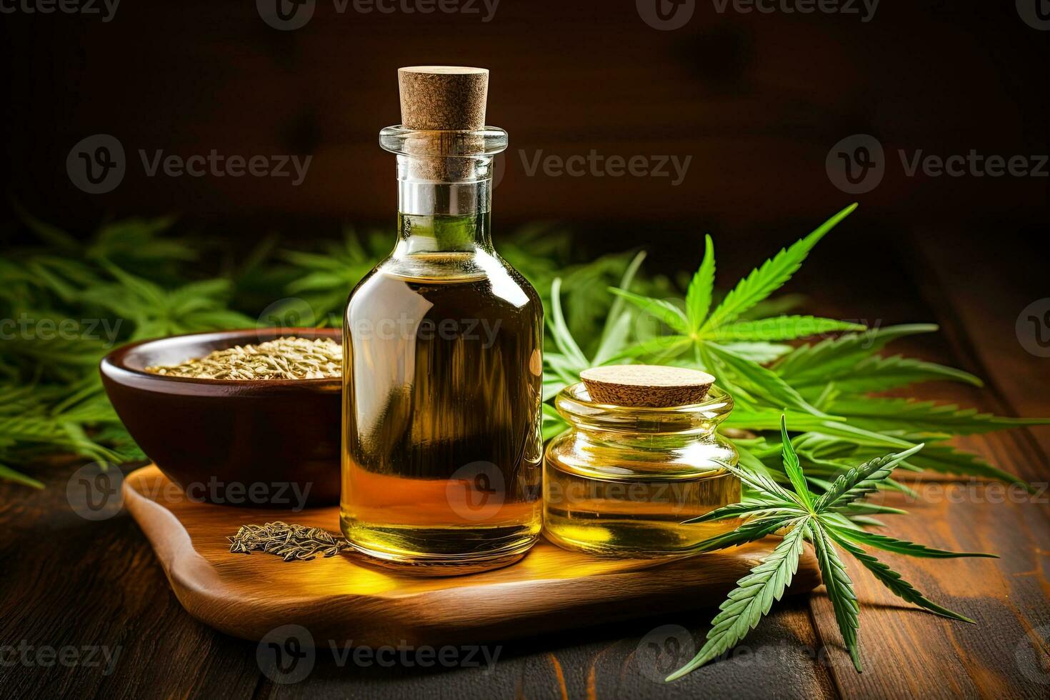 CBD hemp oil in a two bottles and a bowl of seeds on a wooden tray surrounded by hemp leaves on a dark background photo