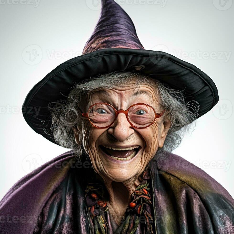 Elderly gray-haired woman in glasses, purple witch hat and outfit laughing on white background photo