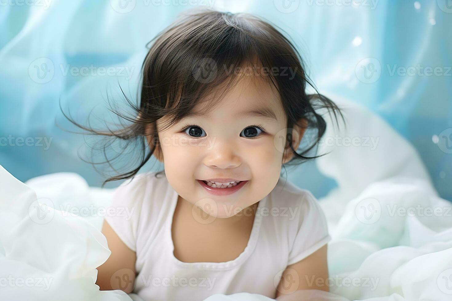 portrait of smiling asian baby girl in her bed photo