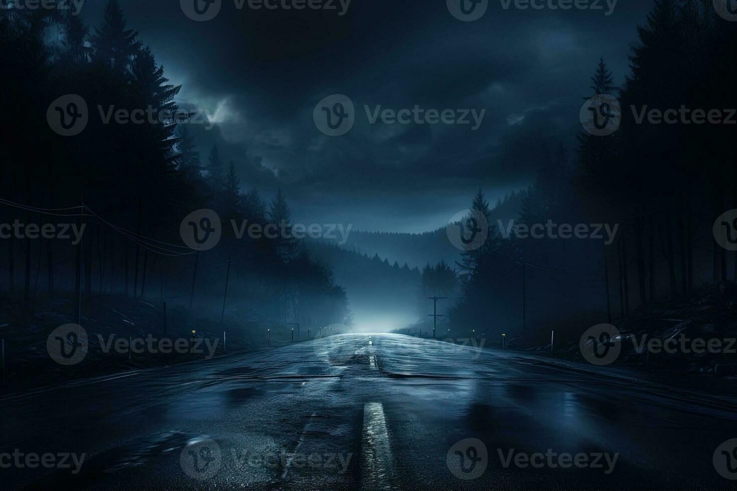 Scary lightless night asphalt mountain road among fir trees and covered with fog photo