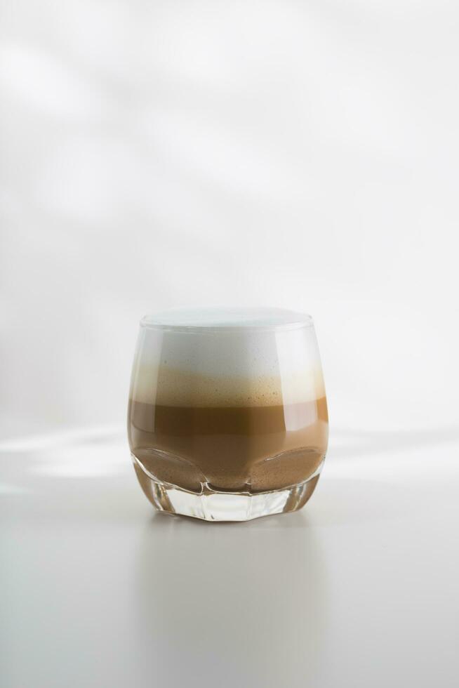 Iced cappuccino in a plastic glass on a white wooden table photo