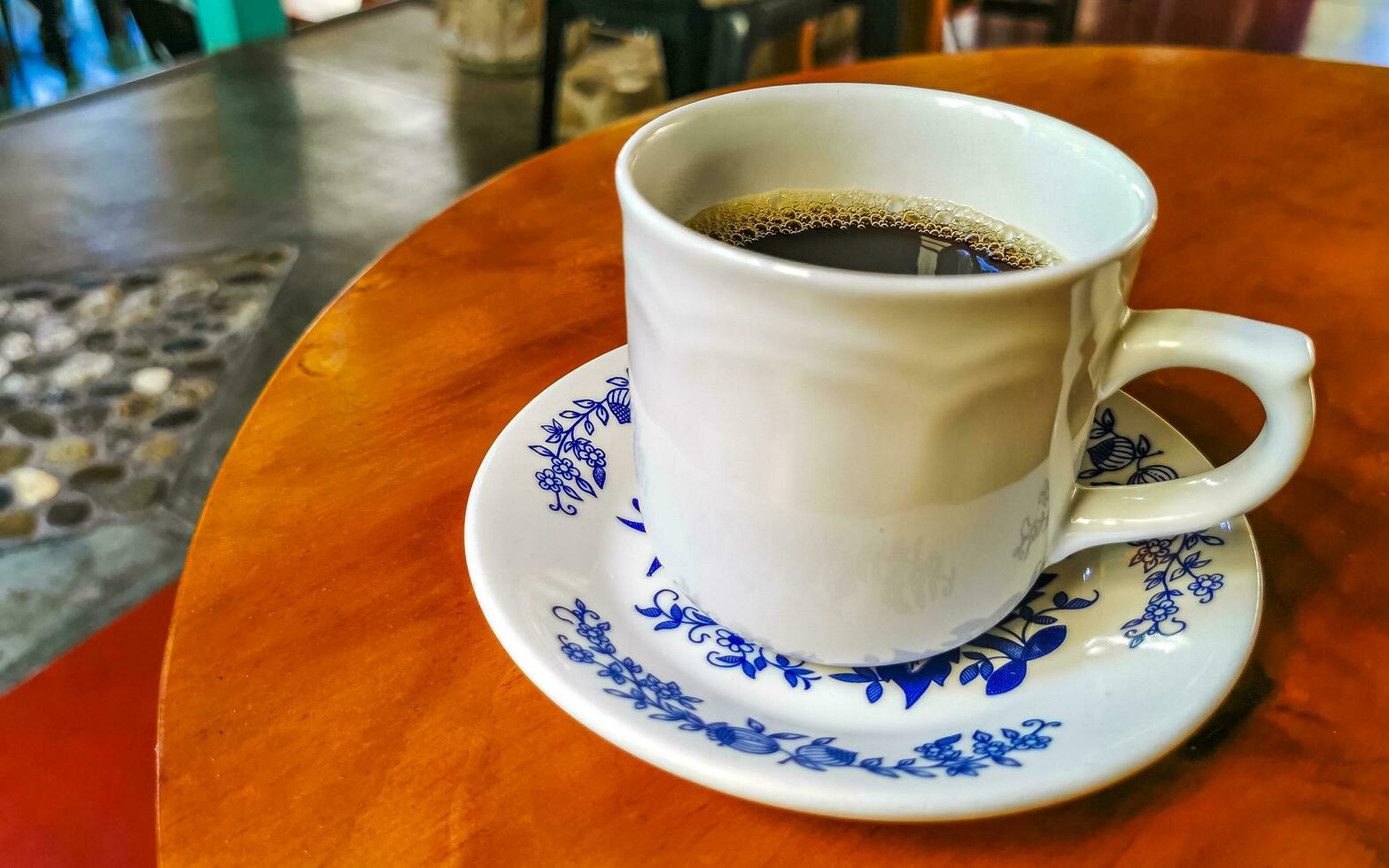 Blue white cup pot with black coffee wooden table Mexico. photo