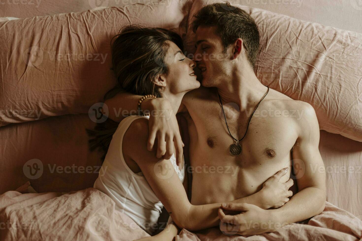 Intimate young couple lying in bed photo