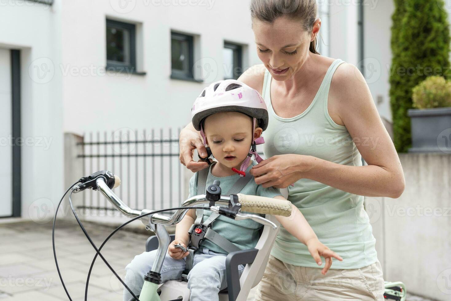 daugther sit and riding Mother and daughter, daughter wearing helmet sitting in children's seat  29800117 Stock Photo at Vecteezy