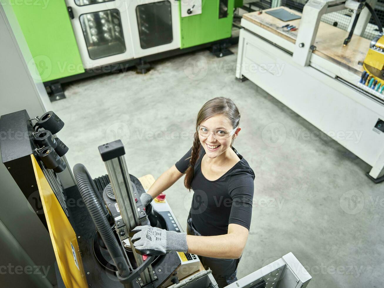 Young woman working on a machine photo