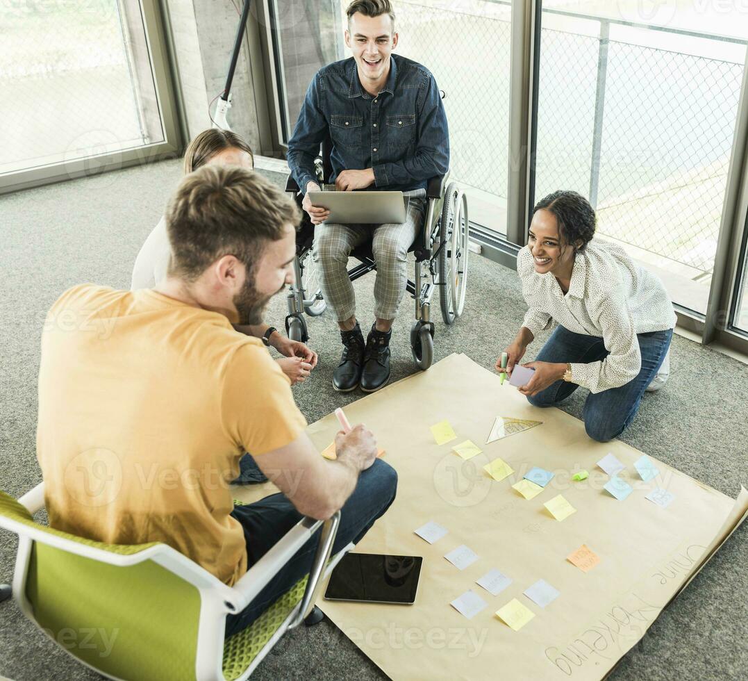 Happy young business people working together on a project in office photo