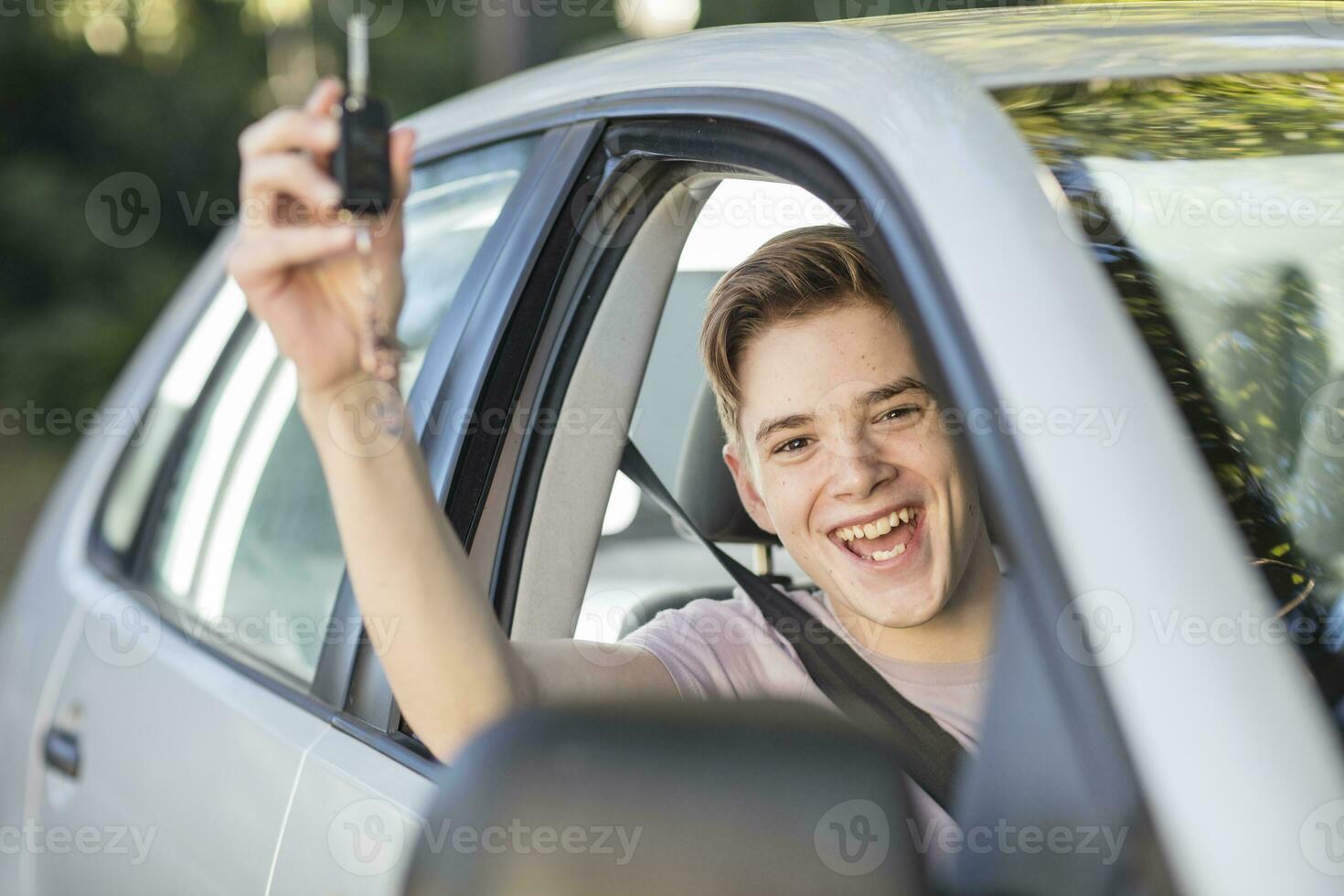Happy learner driver cheering and holding car key photo