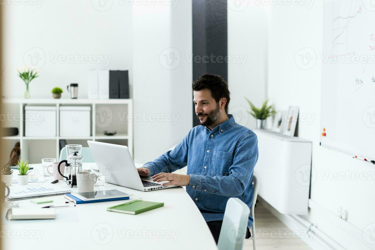 Man using laptop in office photo