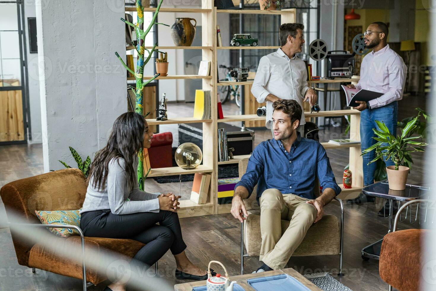 Business team having an informal meeting in loft office photo