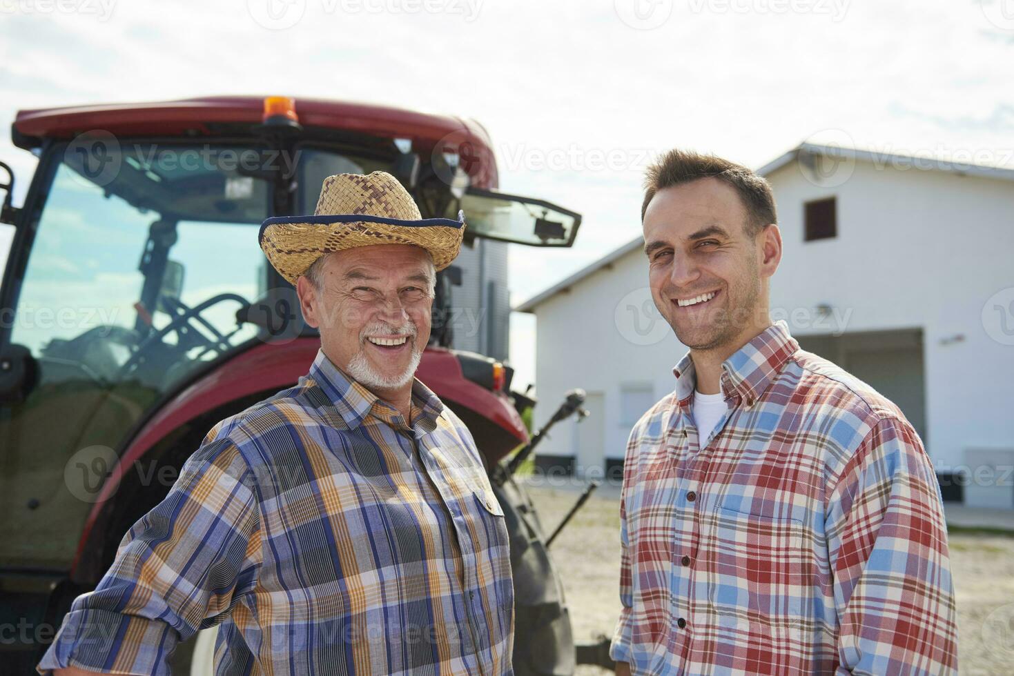 Portrait of two farmers in front of the barn photo