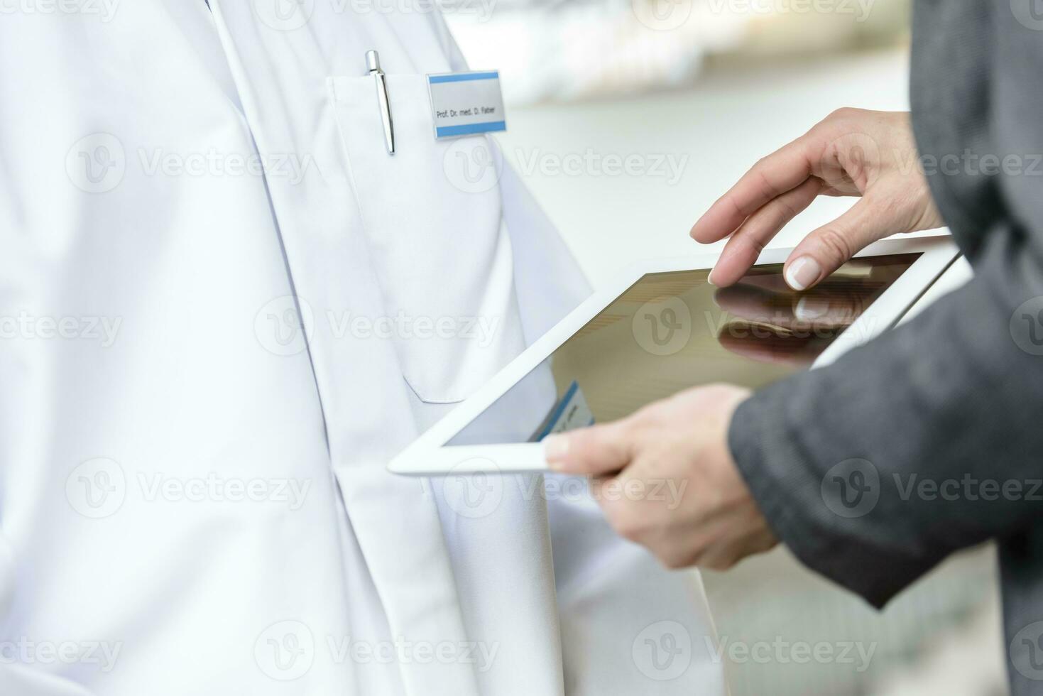 Close-up of businesswoman with tablet and doctor photo