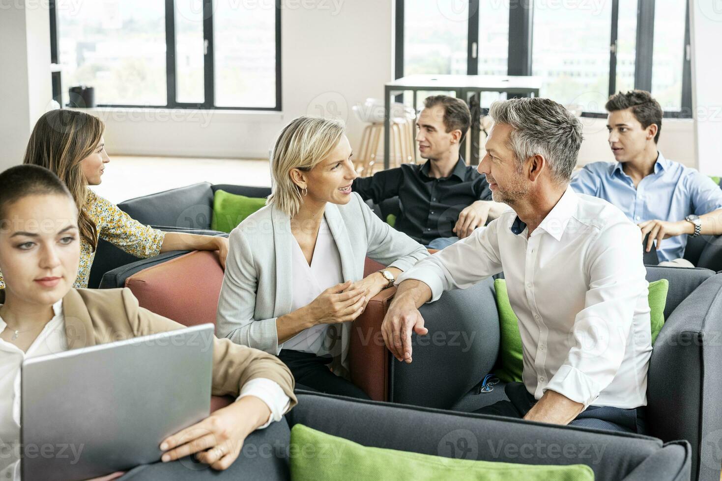 Business people meeting in sitting corner, talking photo