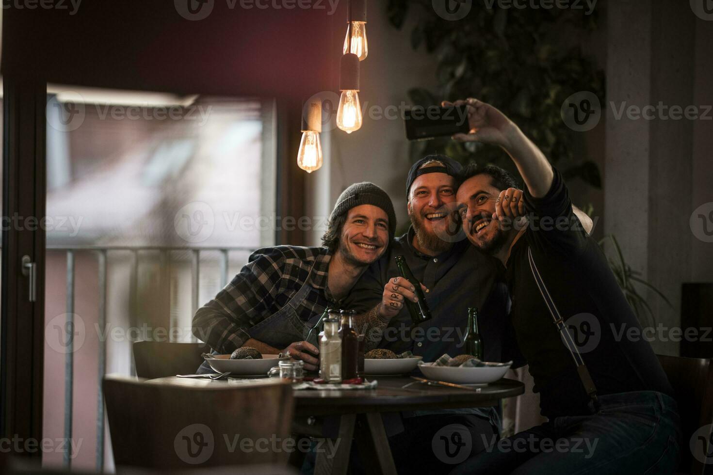 Friends eating what they have cooked and taking selfies photo