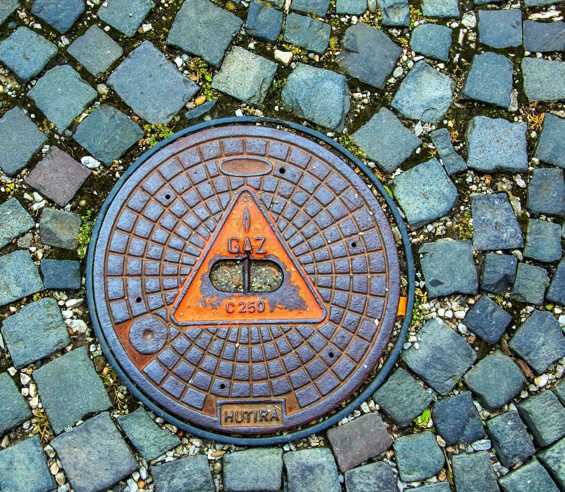 Manhole cover of the gas pipeline system. A massive metal hatch for access to city communications in the pavement. photo