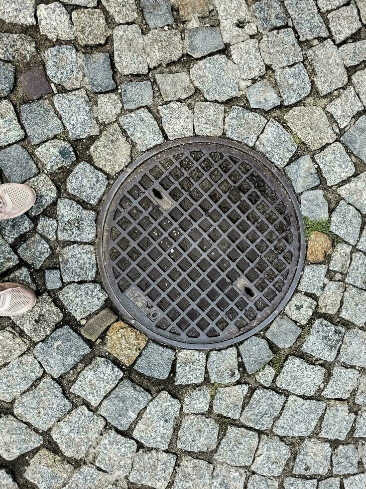 Manhole cover of the gas pipeline system. A massive metal hatch for access to city communications in the pavement. photo