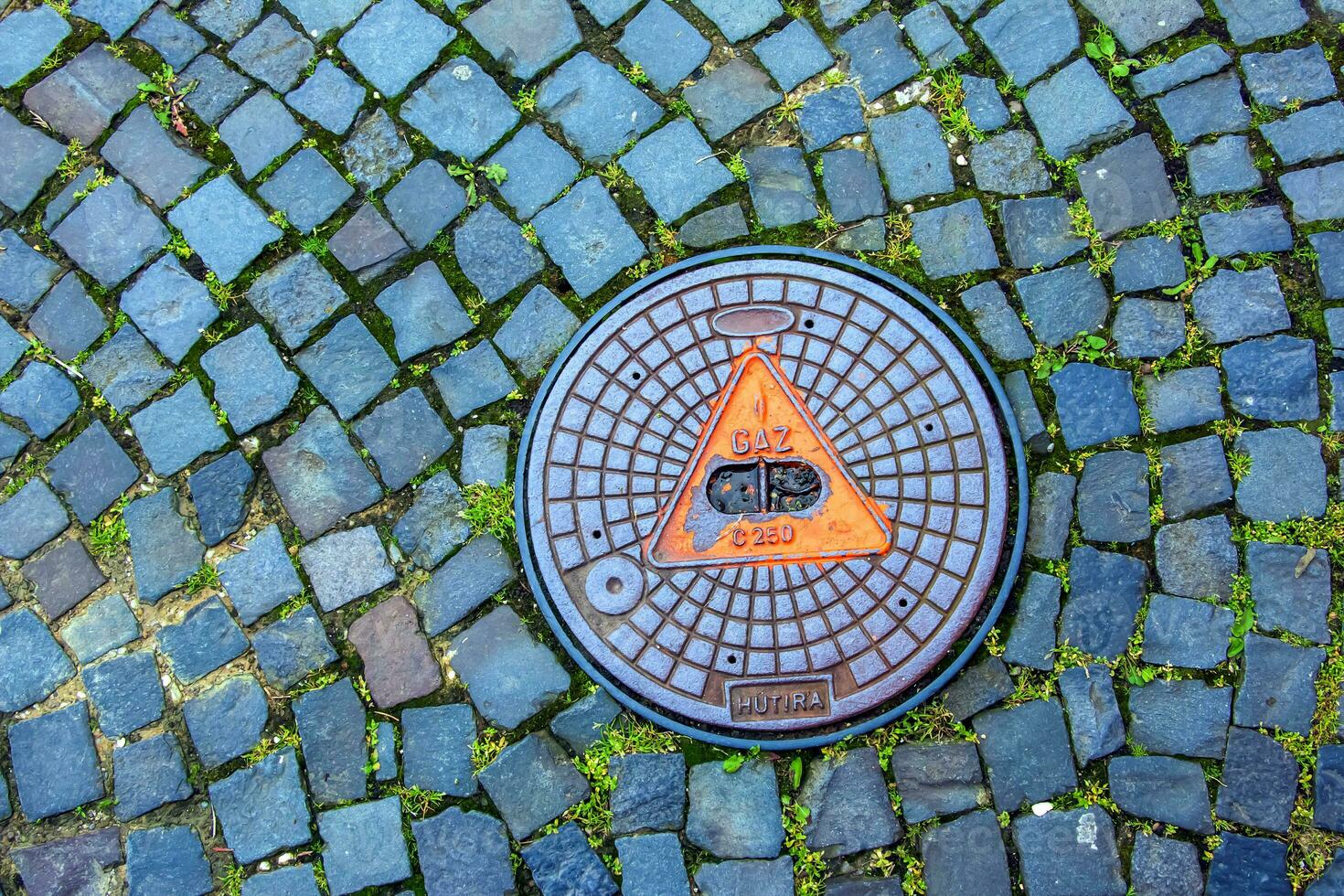 Manhole cover of the gas pipeline system. A massive metal hatch for access to city communications in the pavement. photo