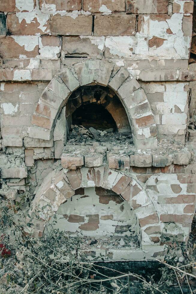 Destroyed old brick home stove concept photo. Damaged vintage oven on backyard. photo