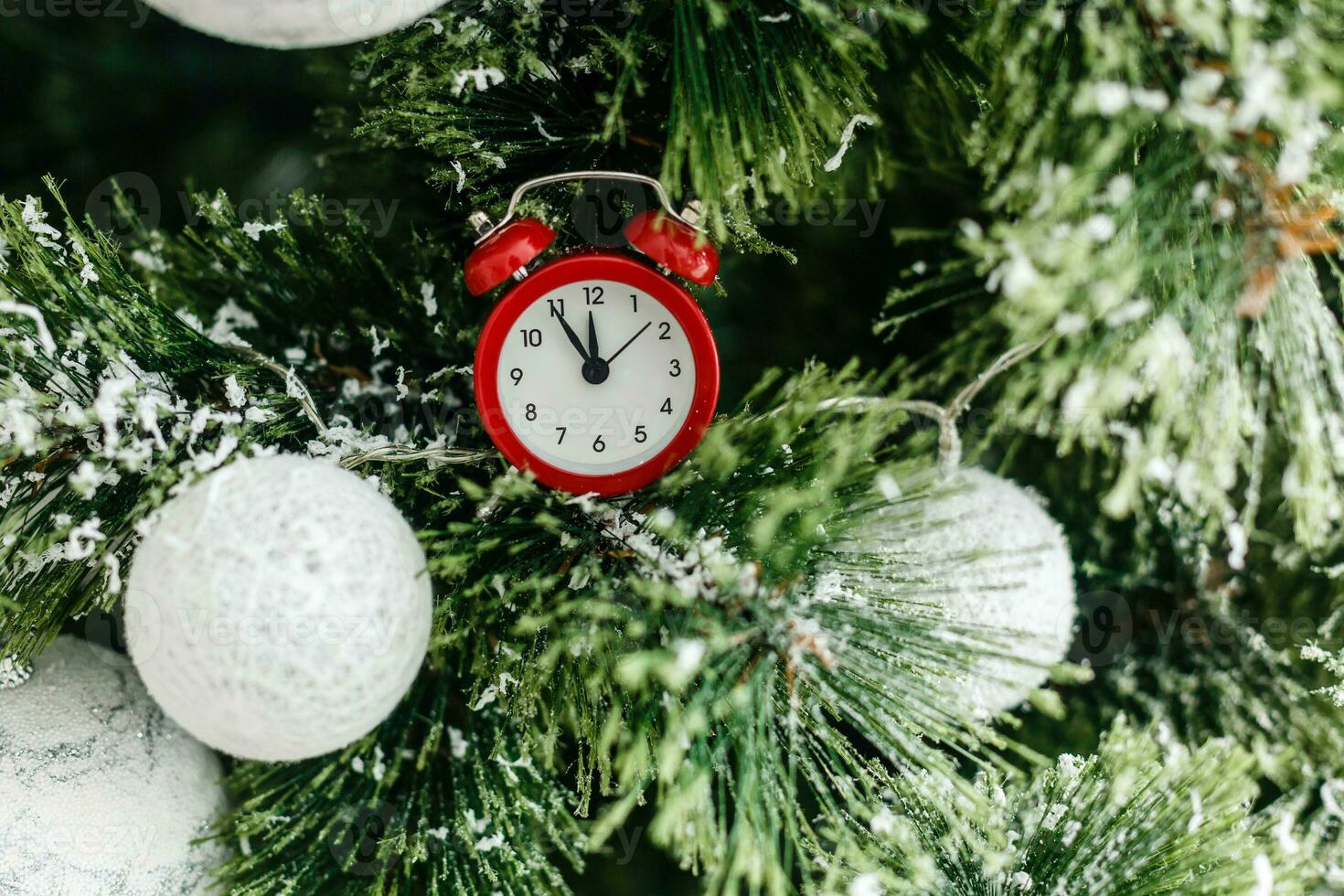 New Year and Christmas background - glass Christmas toy on snowy fir tree branch. photo