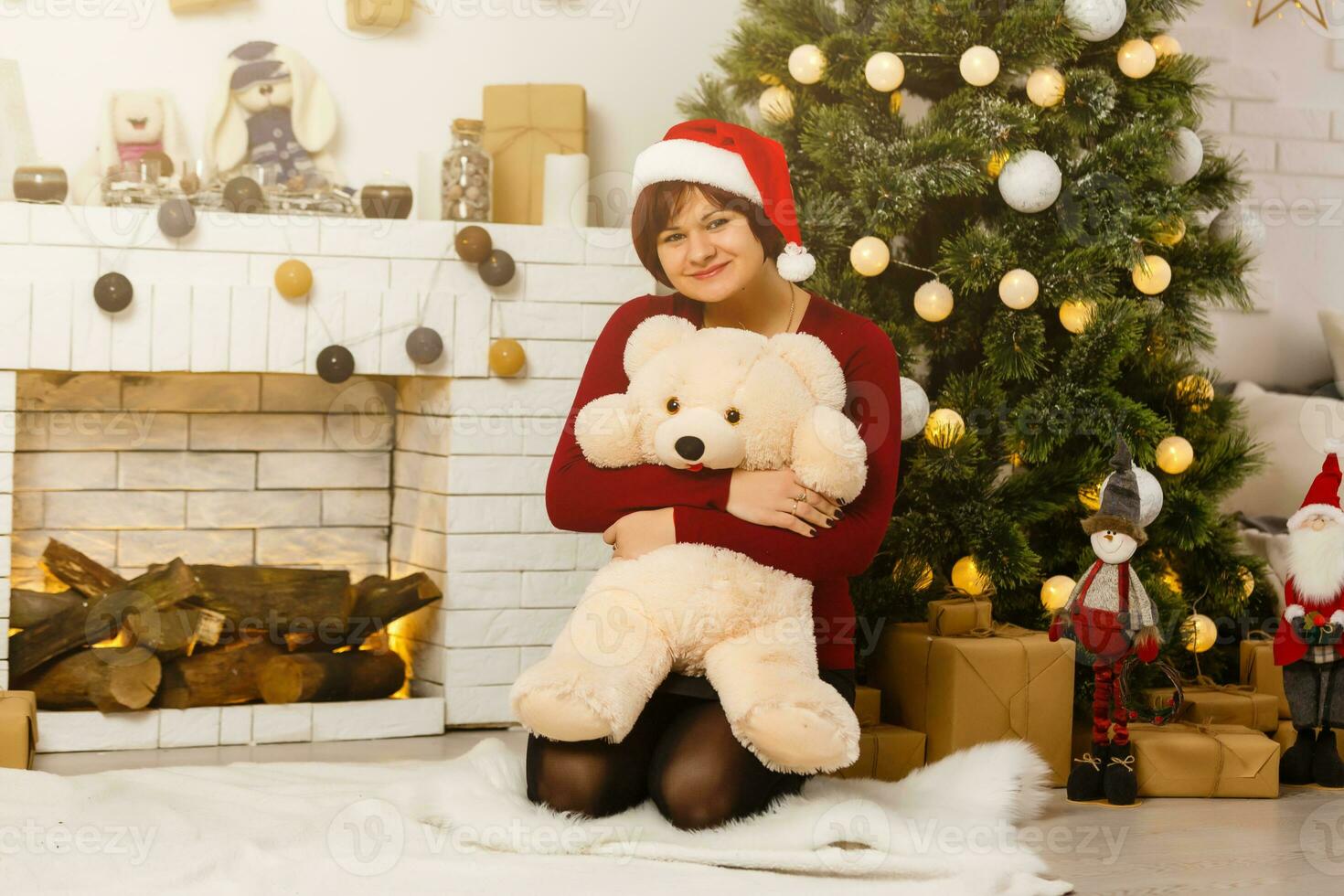 Christmas holiday, girl in santa hat received a Xmas gift photo