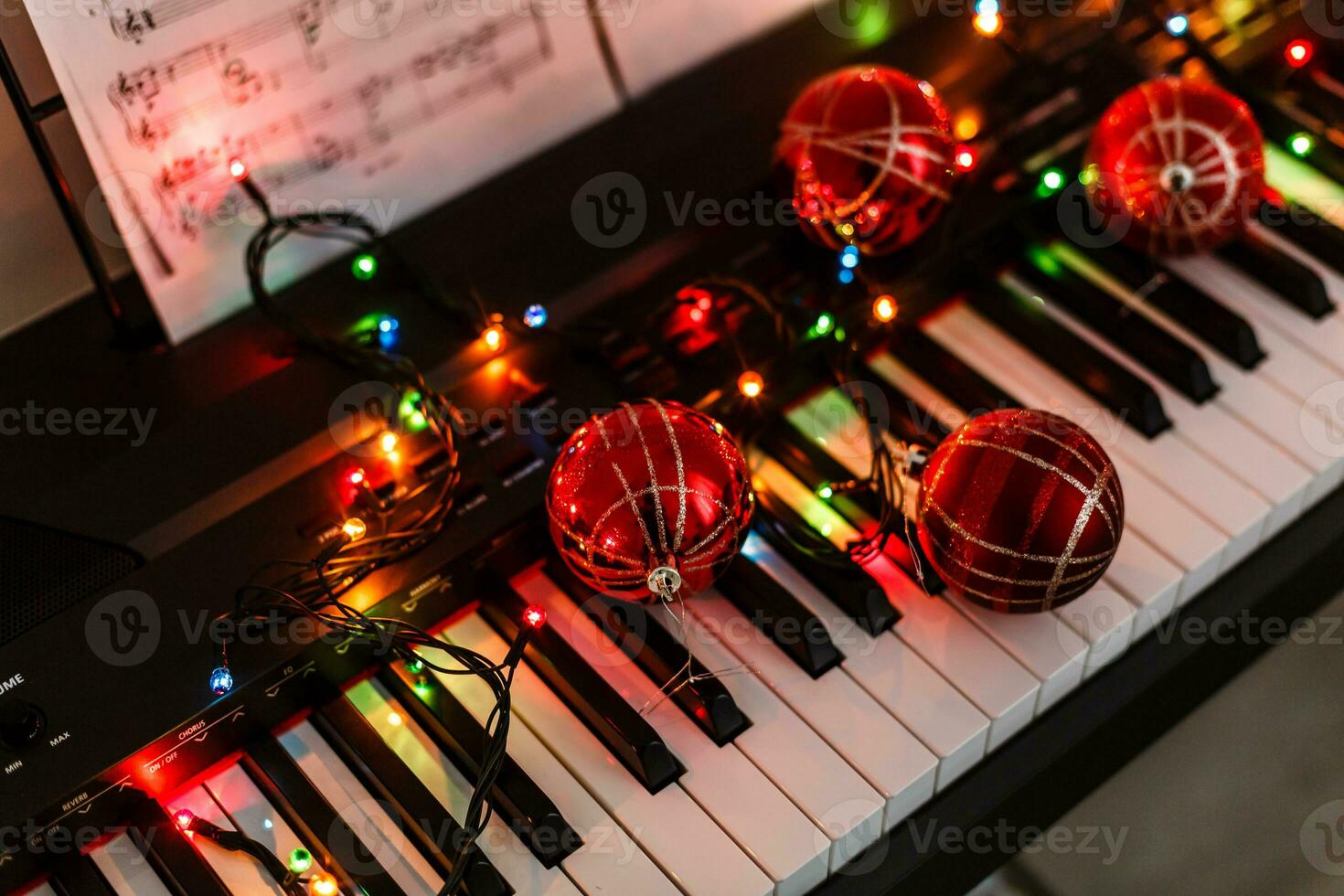 Piano keyboard with Christmas decoration, closeup photo