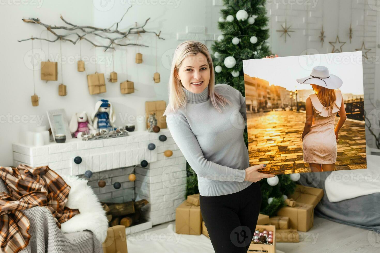 Portrait of attractive cheerful girl i holding gift canvas photo