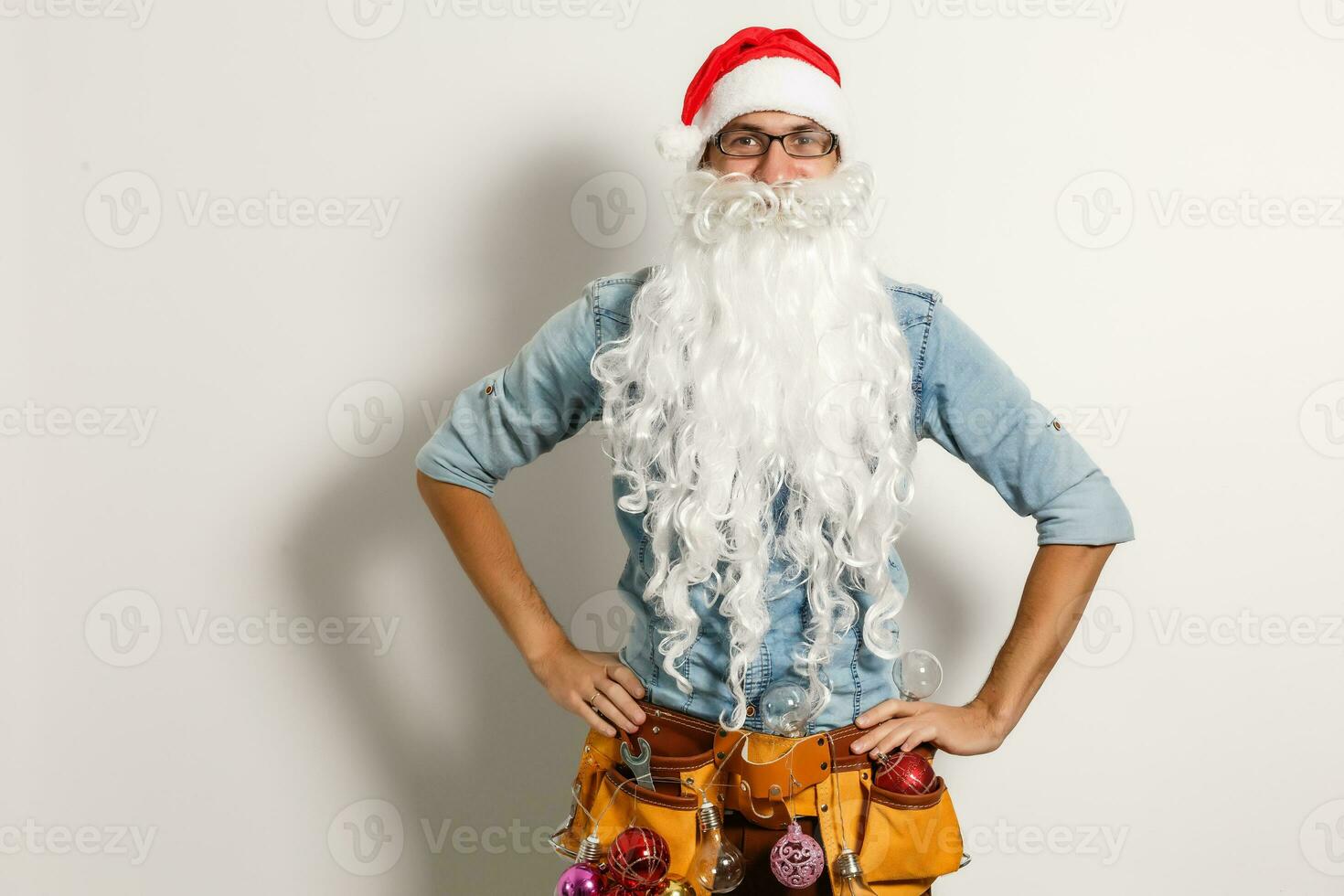 Santa Claus. Young Happy Emotional Santa Man Winner Gesture. Christmas sack bag, Presents Having Fun. New Year. Stylish Colorful New Year Holiday photo