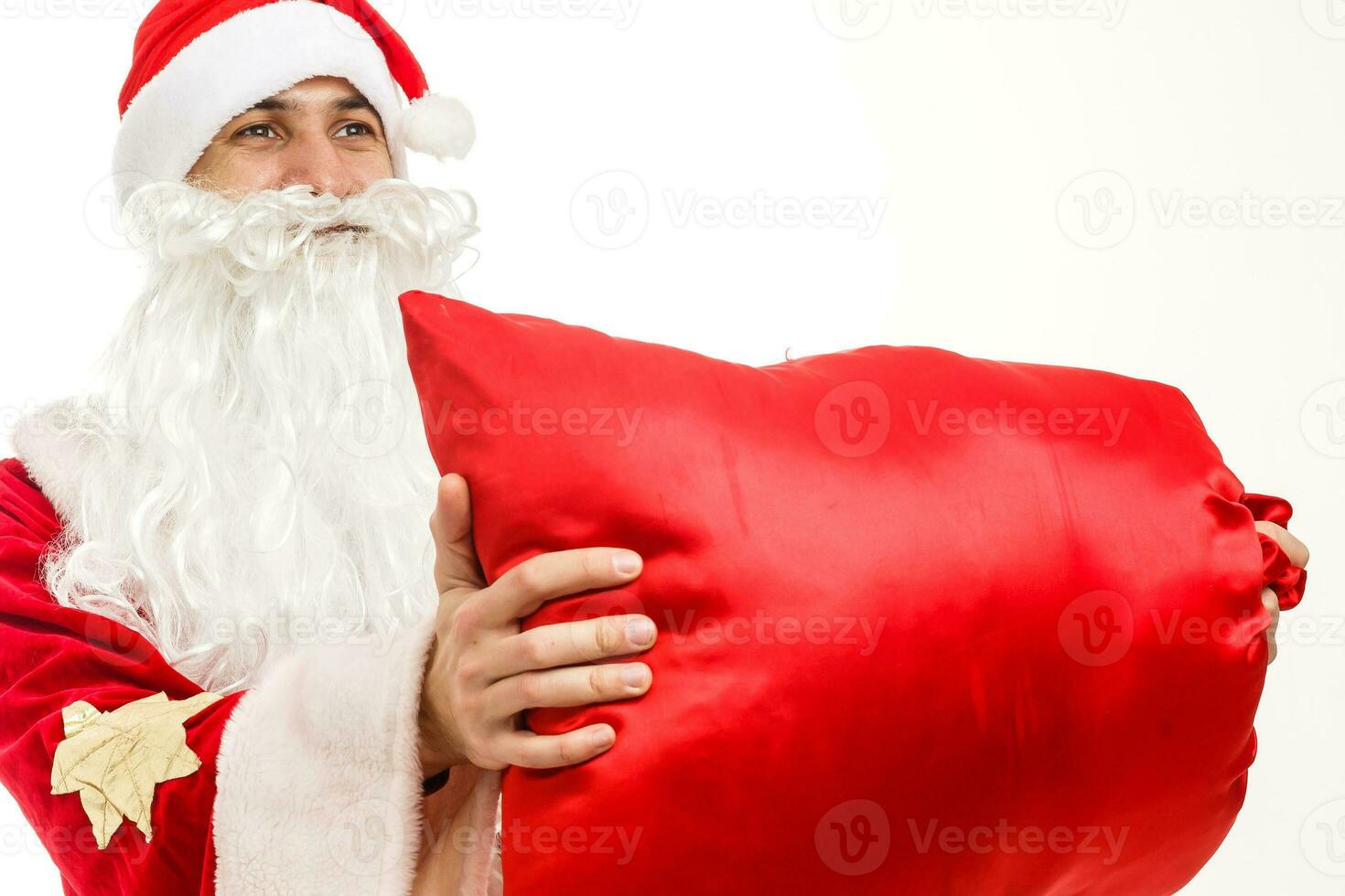 Santa claus holding a gifts against white background photo