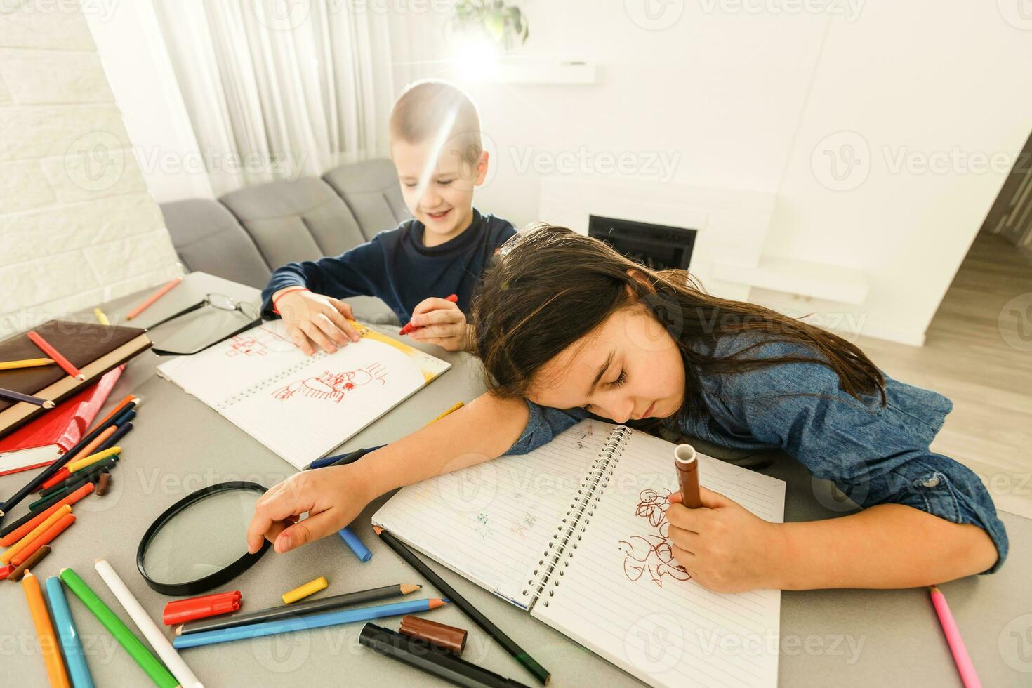 education, elementary school, learning and people concept - group of school kids with pens and notebooks writing test in classroom photo