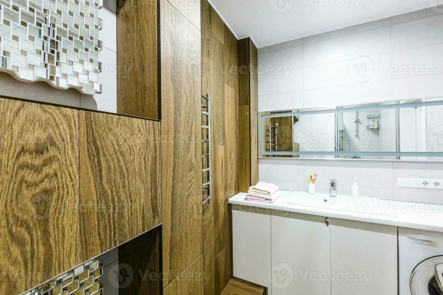 Large furnished bathroom in luxury home with tile floor, fancy cabinets, large mirror, shower, and bathtub photo