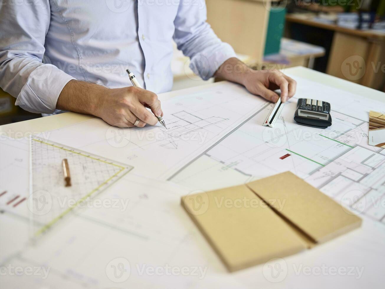 Architect working on construction drawing photo