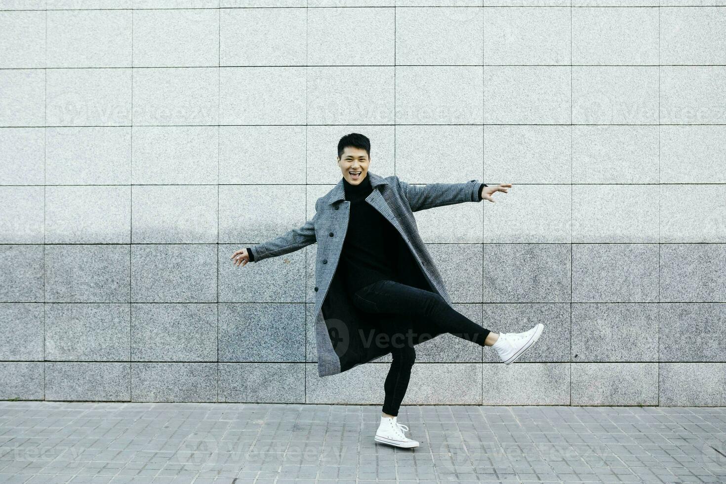 Stylish young man dancing on the street photo