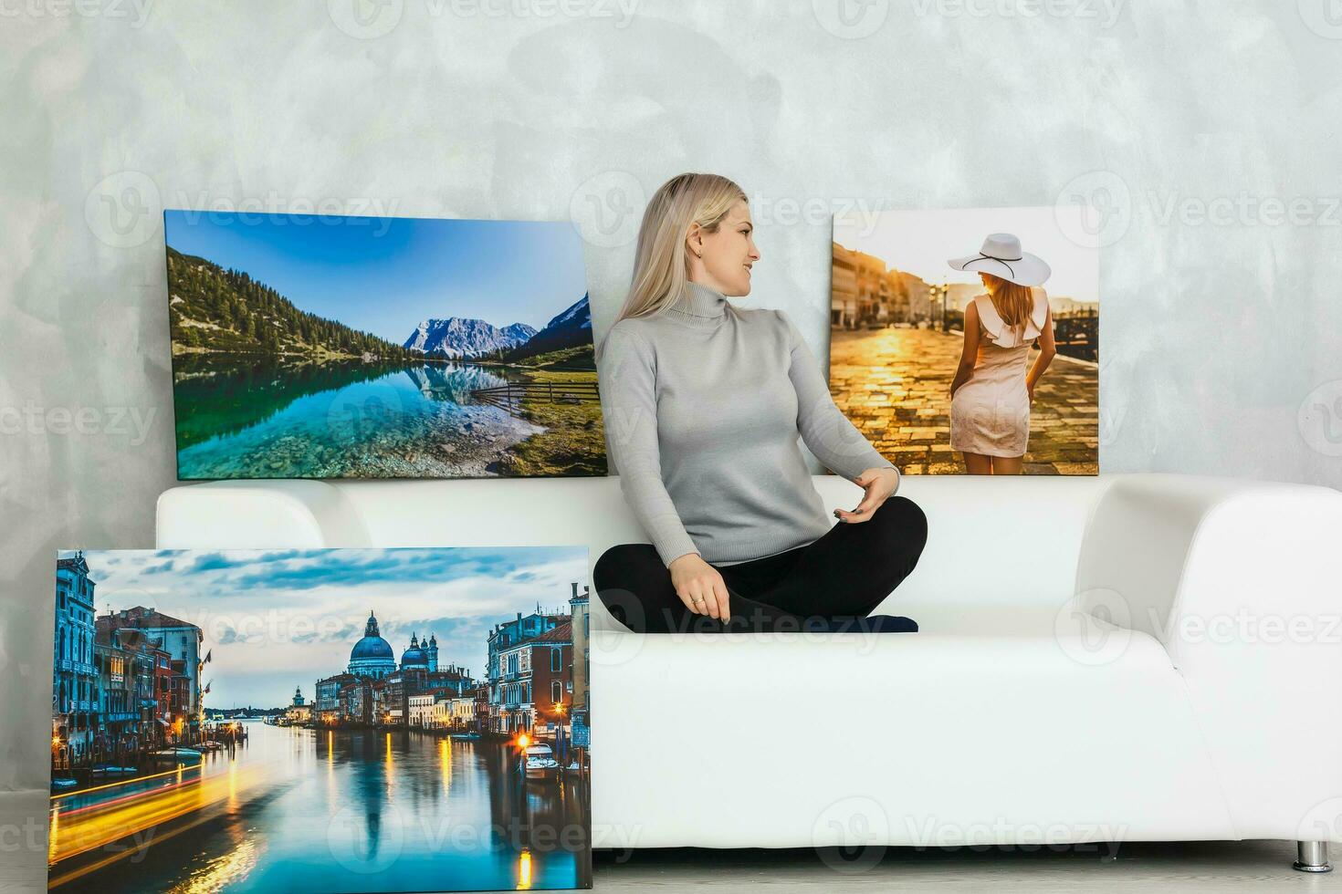 Young girl holds photo canvas at home on the couch