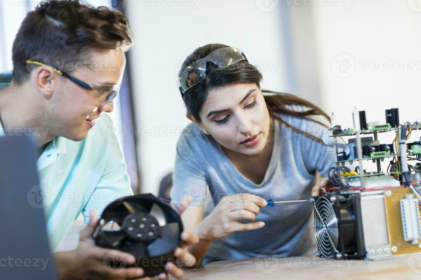 Colleagues working on computer equipment photo