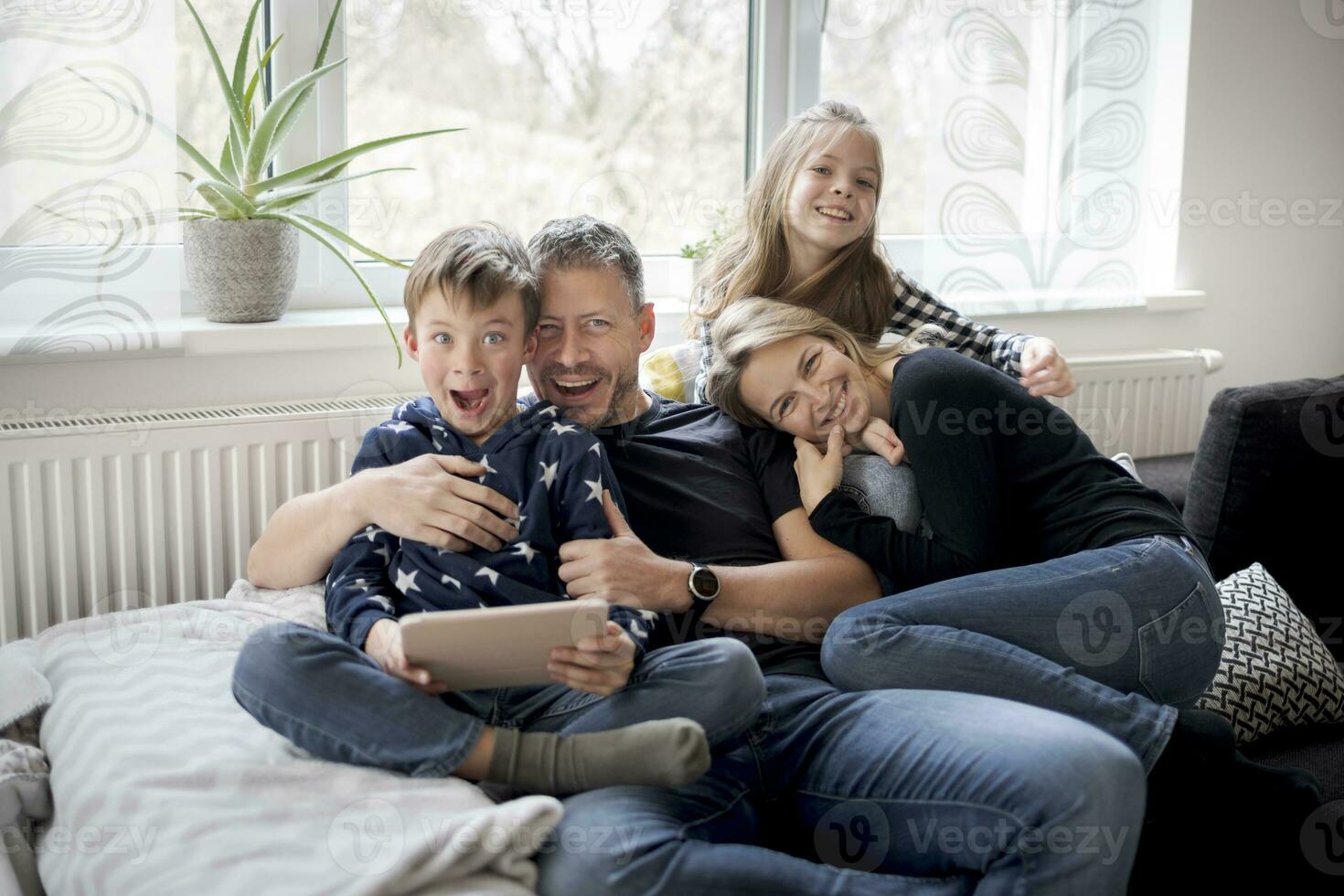 Portrait of playful family on couch at home photo