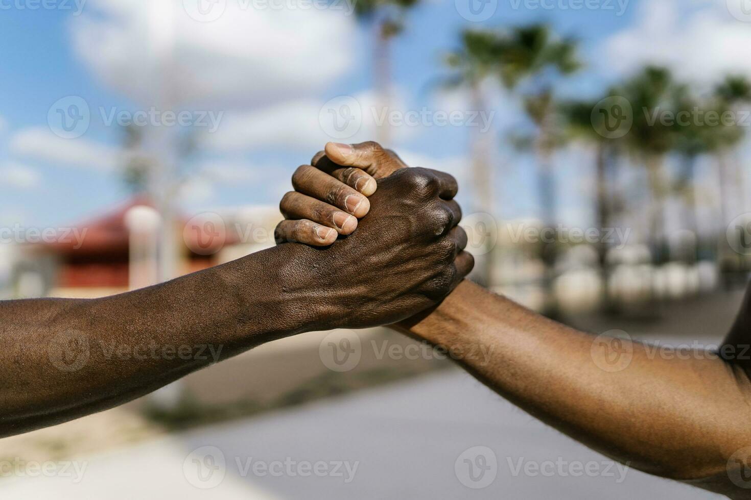 Young men shaking hands on outdoor basketball court photo